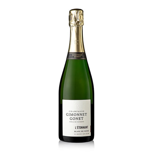 Bottiglia di champagne Gimonnet Gonet l'Etonnant Blanc de Noirs 1Cru brut, 750 ml, con etichetta dorata e capsula nera, su un tavolo di legno accanto a due bicchieri da champagne