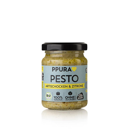Glas mit 120 g Ppura Pesto von Artischocke, Petersilie und Zitrone, Bio-Produkt, IT-BIO-006, das an eine dampfende Schüssel Pasta in einem toskanischen Garten erinnert, liebevoll zubereitet wie von Nonna