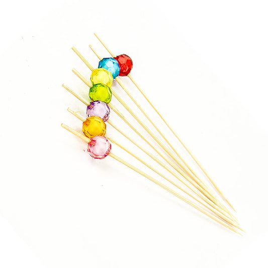 Pics en bambou de 12 cm de long avec des perles de cristal rondes, claires et colorées à l'extrémité pour des amuse-gueules et des snacks attrayants.