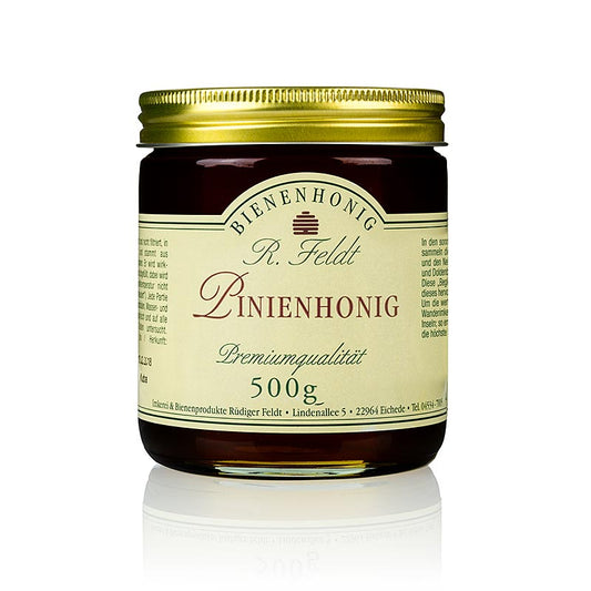 Miele di pino Miele scuro di bosco di pino mite e speziato, con vegetazione di erbe.